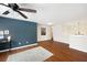 Bright, open living room featuring beautiful hardwood floors, a dark accent wall, and modern lighting at 935 Mill Creek Ave, Canton, GA 30115