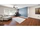Bright living room featuring hardwood floors, ceiling fan and a workstation setup, perfect for a home office at 935 Mill Creek Ave, Canton, GA 30115