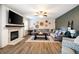 Inviting living room featuring a fireplace, modern decor, large sectional sofa, and lots of light at 935 Mill Creek Ave, Canton, GA 30115