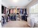 Spacious walk-in closet with custom shelving, ample storage and a convenient laundry hamper at 935 Mill Creek Ave, Canton, GA 30115