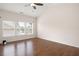 Bright bedroom featuring gleaming hardwood floors, ceiling fan and three windows letting in plenty of natural light at 1957 Brightleaf Way # 59, Marietta, GA 30060