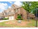 Brick townhome showcasing manicured lawn and an attached two-car garage at 1957 Brightleaf Way # 59, Marietta, GA 30060