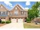 Charming brick townhome with a two-car garage, manicured lawn, and inviting curb appeal at 1957 Brightleaf Way # 59, Marietta, GA 30060