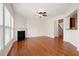 Well lit living room with a fireplace, ceiling fan, hardwood floors, and large windows at 1957 Brightleaf Way # 59, Marietta, GA 30060