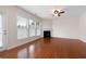 Bright and airy living room with hardwood floors, fireplace, and view of fenced backyard at 1957 Brightleaf Way # 59, Marietta, GA 30060