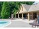 Poolside lounge area with shaded seating and manicured landscaping at 1957 Brightleaf Way # 59, Marietta, GA 30060