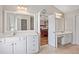 Bright bathroom featuring a double sink vanity, mirrors and doorway leading to main bedroom at 3133 Dunton Se St, Smyrna, GA 30080