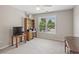Bedroom with light grey walls, carpet floors, a wooden desk and a view of the outside at 3133 Dunton Se St, Smyrna, GA 30080