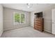 Well lit bedroom featuring a large window, neutral walls, grey carpeting and a ceiling fan at 3133 Dunton Se St, Smyrna, GA 30080