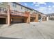 Townhome garages and rear entrances with brick accents and balcony views above at 3133 Dunton Se St, Smyrna, GA 30080
