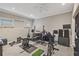 Home gym featuring workout equipment, speakers, weight rack, and wall mounted TV at 3133 Dunton Se St, Smyrna, GA 30080
