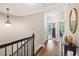 Upstairs hallway featuring hardwood floors and modern lighting at 3133 Dunton Se St, Smyrna, GA 30080