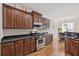 Stylish kitchen featuring stainless steel appliances, dark cabinets, and gleaming hardwood floors at 3133 Dunton Se St, Smyrna, GA 30080