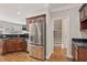 Well-equipped kitchen with stainless steel refrigerator, dark countertops, and hardwood flooring at 3133 Dunton Se St, Smyrna, GA 30080
