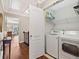 Laundry room featuring a washer, dryer, wire shelving, and hardwood floors at 3133 Dunton Se St, Smyrna, GA 30080