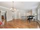 Inviting open-concept living area with hardwood floors, piano, and elegant lighting at 3133 Dunton Se St, Smyrna, GA 30080