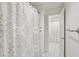 Well-lit bathroom featuring a decorative shower curtain and tiled floors at 3475 Oak Valley Ne Rd # 2060, Atlanta, GA 30326