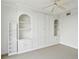 Bright bedroom featuring built-in shelving, cabinets, plush carpet, and a ceiling fan at 3475 Oak Valley Ne Rd # 2060, Atlanta, GA 30326
