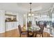 Bright dining room with hardwood floors, modern lighting, and a view into the kitchen and living area at 3475 Oak Valley Ne Rd # 2060, Atlanta, GA 30326