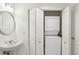 Compact laundry space with a stacked washer and dryer next to a sink at 3475 Oak Valley Ne Rd # 2060, Atlanta, GA 30326