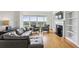 Comfortable living room featuring a fireplace, built-in bookshelves, and expansive city views at 3475 Oak Valley Ne Rd # 2060, Atlanta, GA 30326