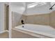 Spa-like bathroom featuring a soaking tub with tile surround and glass-enclosed shower at 3513 Newtons Crest Cir, Snellville, GA 30078