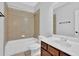 Bathroom showcases a tub and shower, toilet, and vanity with a large mirror above at 3513 Newtons Crest Cir, Snellville, GA 30078