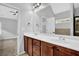 Ensuite bathroom features double sinks with dark cabinets, a large mirror, and granite countertops at 3513 Newtons Crest Cir, Snellville, GA 30078