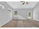 Bright and airy bedroom featuring neutral carpet, a ceiling fan, and a door to the backyard at 3513 Newtons Crest Cir, Snellville, GA 30078