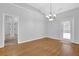 The dining room has hardwood floors, neutral paint, a chandelier and lots of natural light at 3513 Newtons Crest Cir, Snellville, GA 30078