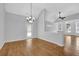 This dining room area features hardwood floors, a modern chandelier, and a walk-out to the backyard at 3513 Newtons Crest Cir, Snellville, GA 30078