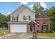 Charming two-story home with brick facade, a two-car garage, manicured lawn, and a welcoming entrance at 3513 Newtons Crest Cir, Snellville, GA 30078