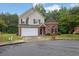 Charming two-story home with brick and siding, attached garage, and mature trees at 3513 Newtons Crest Cir, Snellville, GA 30078