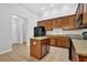Kitchen with an island, black appliances, wooden cabinetry, and granite countertops at 3513 Newtons Crest Cir, Snellville, GA 30078