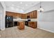 Well-lit kitchen with granite countertops, an island, tiled floors, and modern black appliances at 3513 Newtons Crest Cir, Snellville, GA 30078