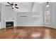 Bright living room boasts a fireplace, hardwood floors, ceiling fan, and ample natural light at 3513 Newtons Crest Cir, Snellville, GA 30078