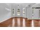 Bright living room features hardwood floors, many windows, and a front door at 3513 Newtons Crest Cir, Snellville, GA 30078