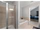 Bright bathroom featuring a tub and shower with tile surround, creating a clean and modern space at 4023 Caitlyn Pl, Atlanta, GA 30360