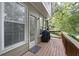 A wooden deck featuring a grill, outdoor seating, and a door leading inside at 4023 Caitlyn Pl, Atlanta, GA 30360