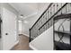 Entrance hallway featuring hardwood floors, metal railing staircase and white doors at 4023 Caitlyn Pl, Atlanta, GA 30360