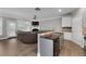 Open floor plan with an island kitchen that flows into the living room with fireplace at 4023 Caitlyn Pl, Atlanta, GA 30360