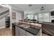 Modern kitchen featuring granite countertops, stainless steel sink, and black appliances at 4023 Caitlyn Pl, Atlanta, GA 30360