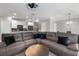Open living space with a large sectional sofa, kitchen view, and hardwood floors at 4023 Caitlyn Pl, Atlanta, GA 30360