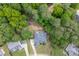A high-angle view of a well-kept brick home with a large yard and plenty of surrounding trees at 4530 Bogan Gates Dr, Buford, GA 30519