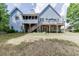 Expansive backyard view featuring a deck, patio, and well-maintained lawn at 4530 Bogan Gates Dr, Buford, GA 30519