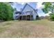 Wide backyard view featuring a deck and well-maintained lawn at 4530 Bogan Gates Dr, Buford, GA 30519