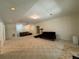 Open basement area with neutral carpet and two dark sofas, perfect for entertainment and recreation at 4530 Bogan Gates Dr, Buford, GA 30519