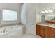Elegant bathroom with a jetted tub, walk-in shower, and vanity with granite countertops at 4530 Bogan Gates Dr, Buford, GA 30519