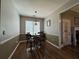 Bright dining area with hardwood floors, a stylish light fixture, and a door to a fireplace makes for a cozy space at 4530 Bogan Gates Dr, Buford, GA 30519