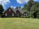 Charming brick home featuring a well-manicured lawn and lush landscaping in a peaceful residential neighborhood at 4530 Bogan Gates Dr, Buford, GA 30519